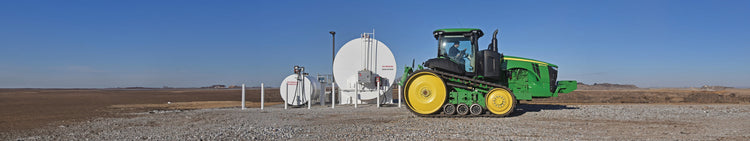 Tractor in Field with Propane Tanks